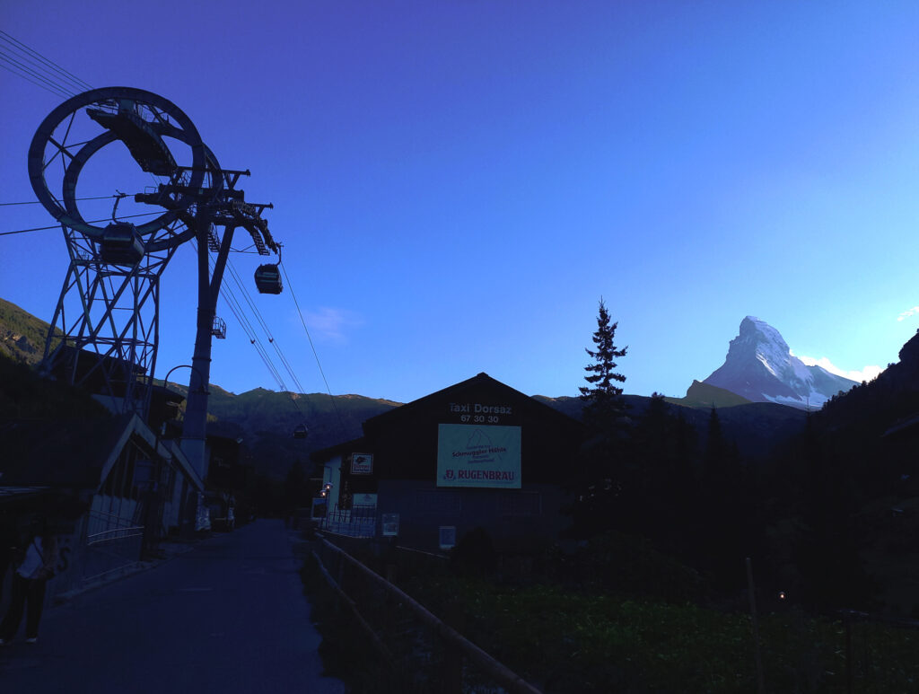 Matternhorn silhouette at sunset above Zermatt with cable car Switzerland