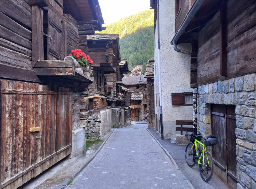 historic wooden chalets along a narrow street in Zermatt, Switzerland