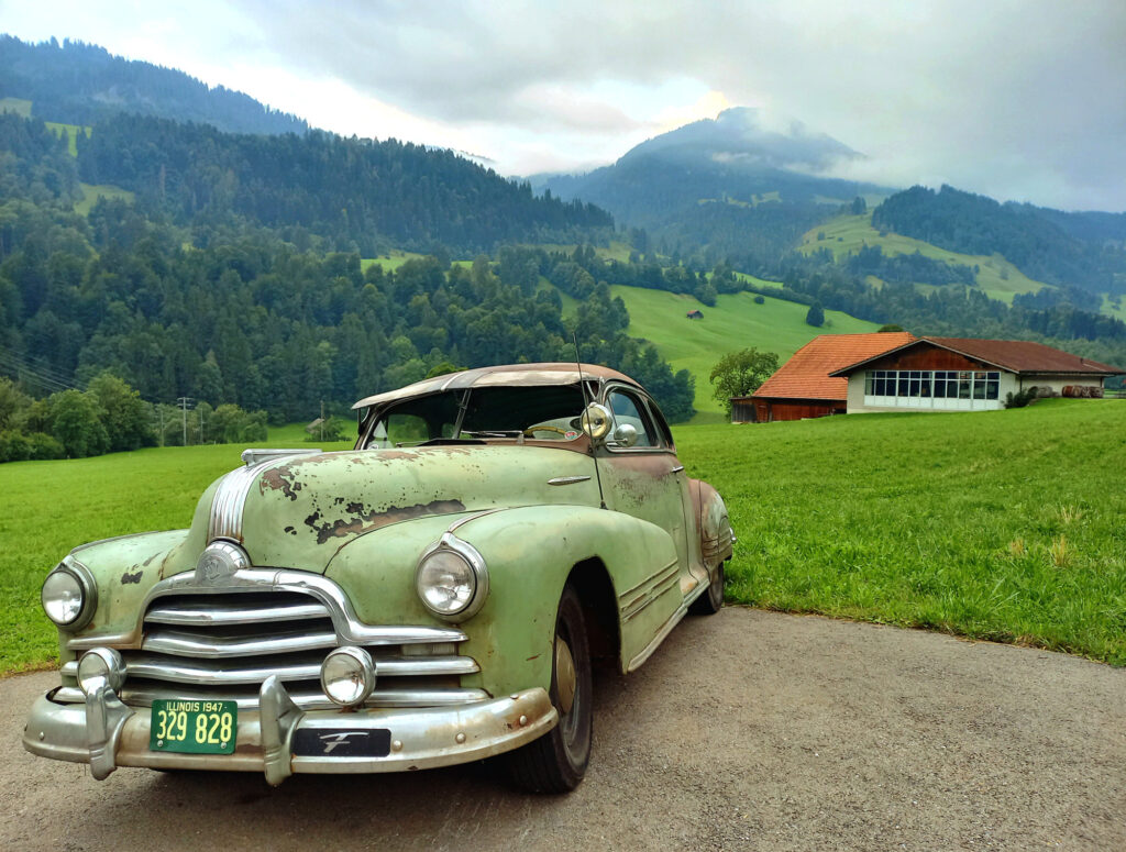 Vintage car in the Bernese Alps on the road to Col du Pillon