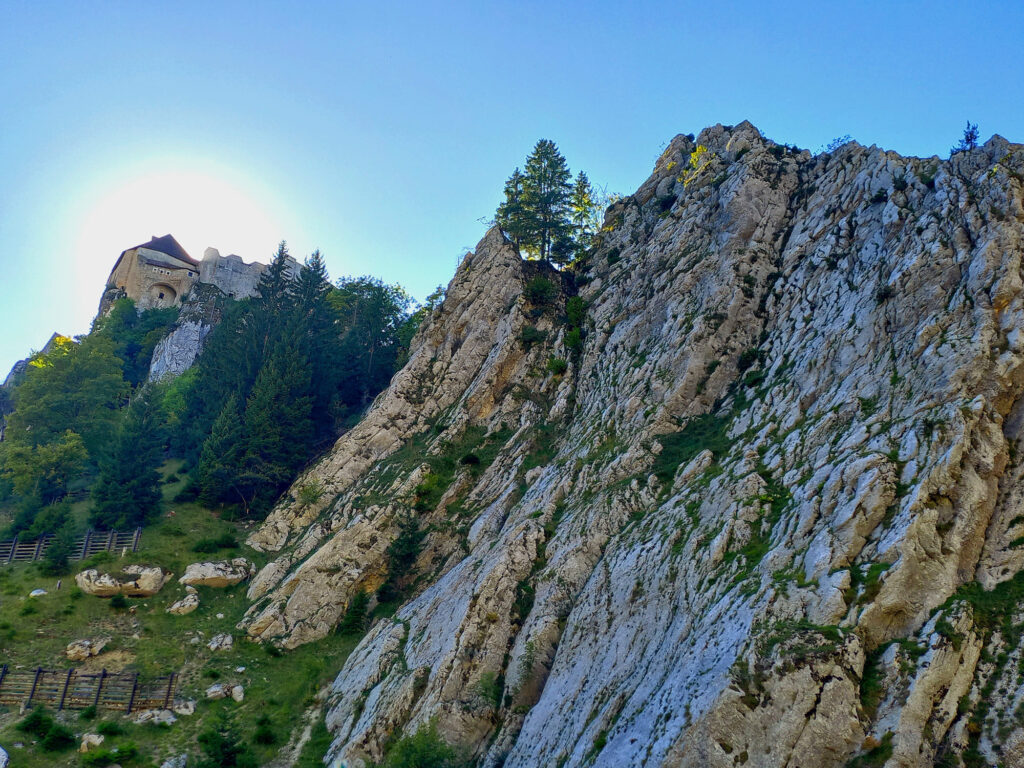 Historic Château de Joux perched above dramatic limestone cliffs in eastern France