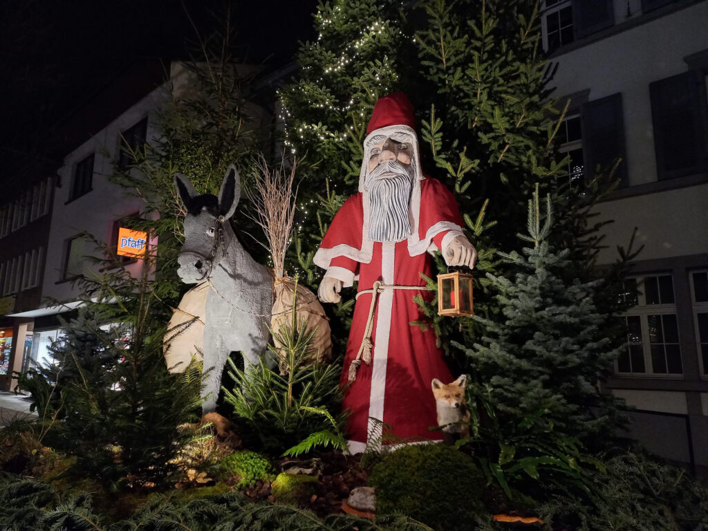 Traditional Saint Nicholas Christmas decoration illuminated during a winter night in Switzerland
