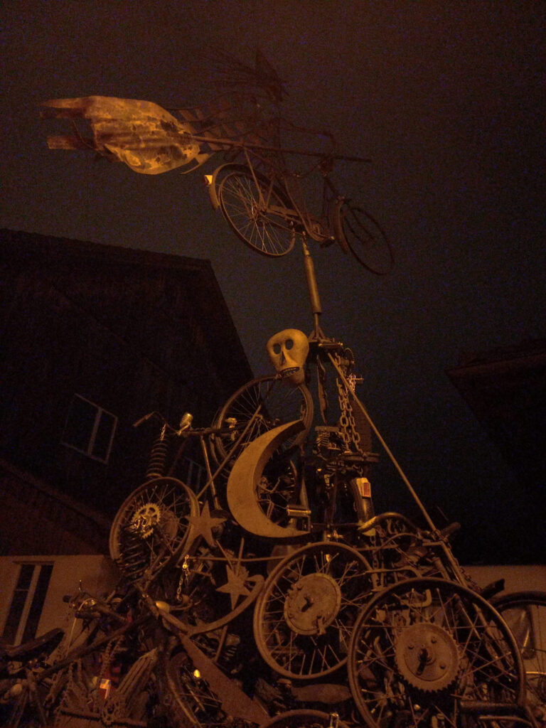 Slightly creepy metal bicycle sculpture during a dark night ride in Switzerland