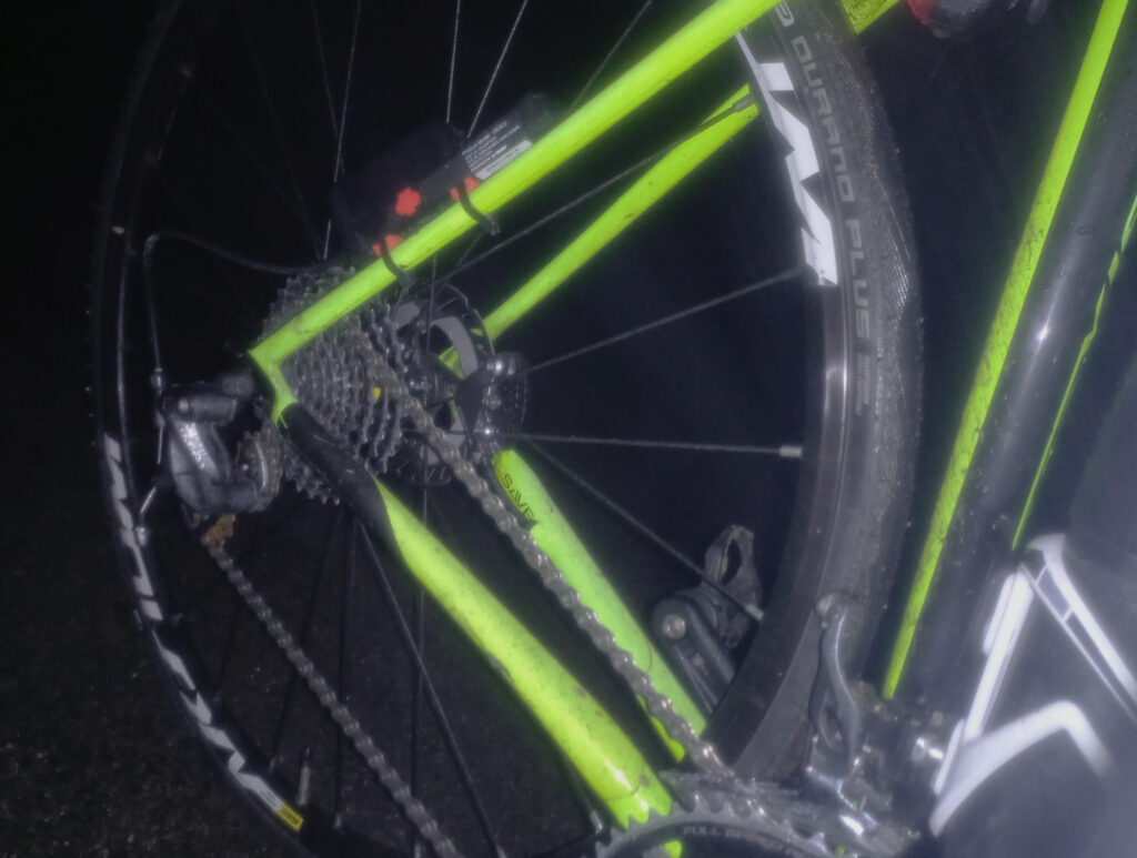 Close-up detail of the L-TWOO drivetrain and rear cassette during a cold night cycling ride