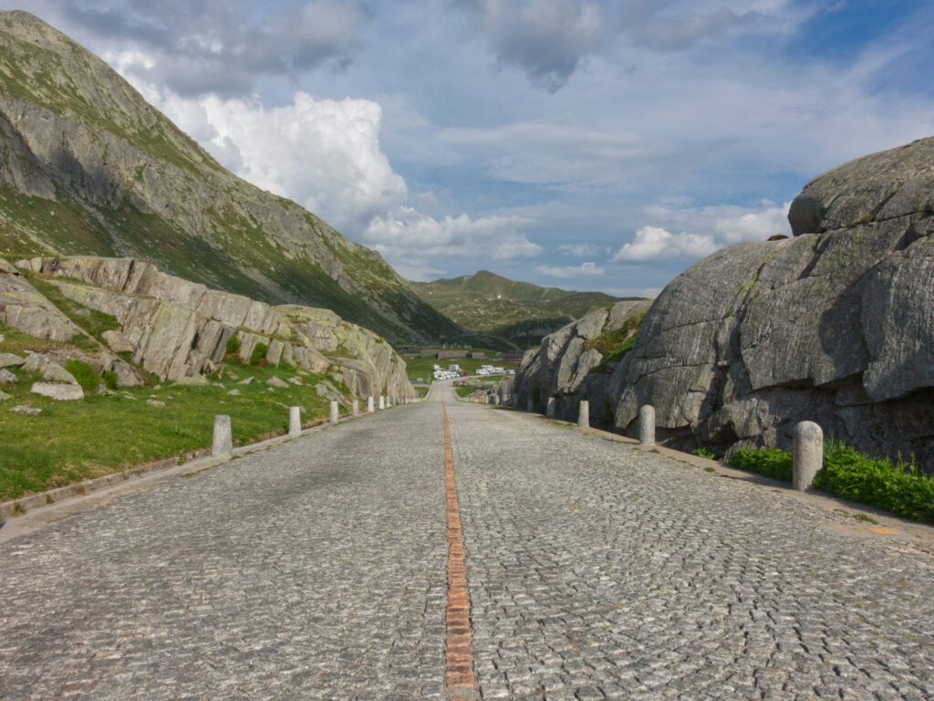 Cobblestone road through granite rocks on Gotthard Pass.