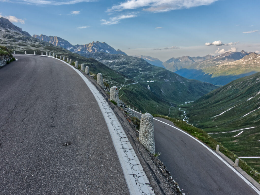Hairpin road above the alpine valley on Furka Pass.