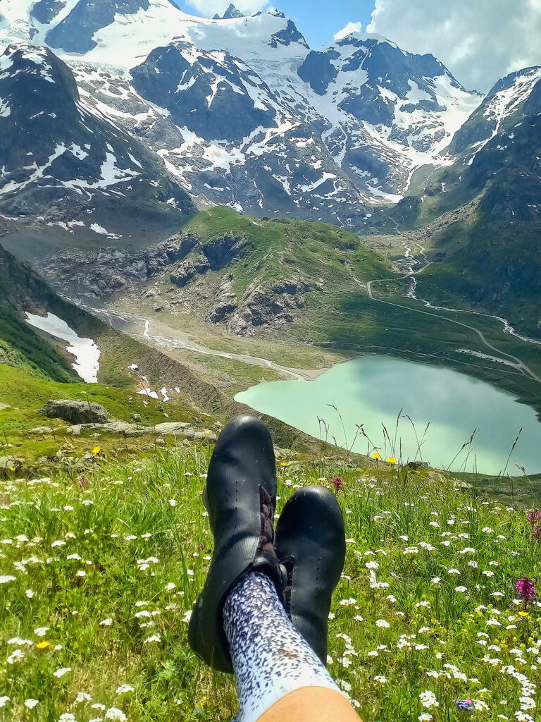 View over an alpine lake and snowy peaks while resting on Susten Pass.