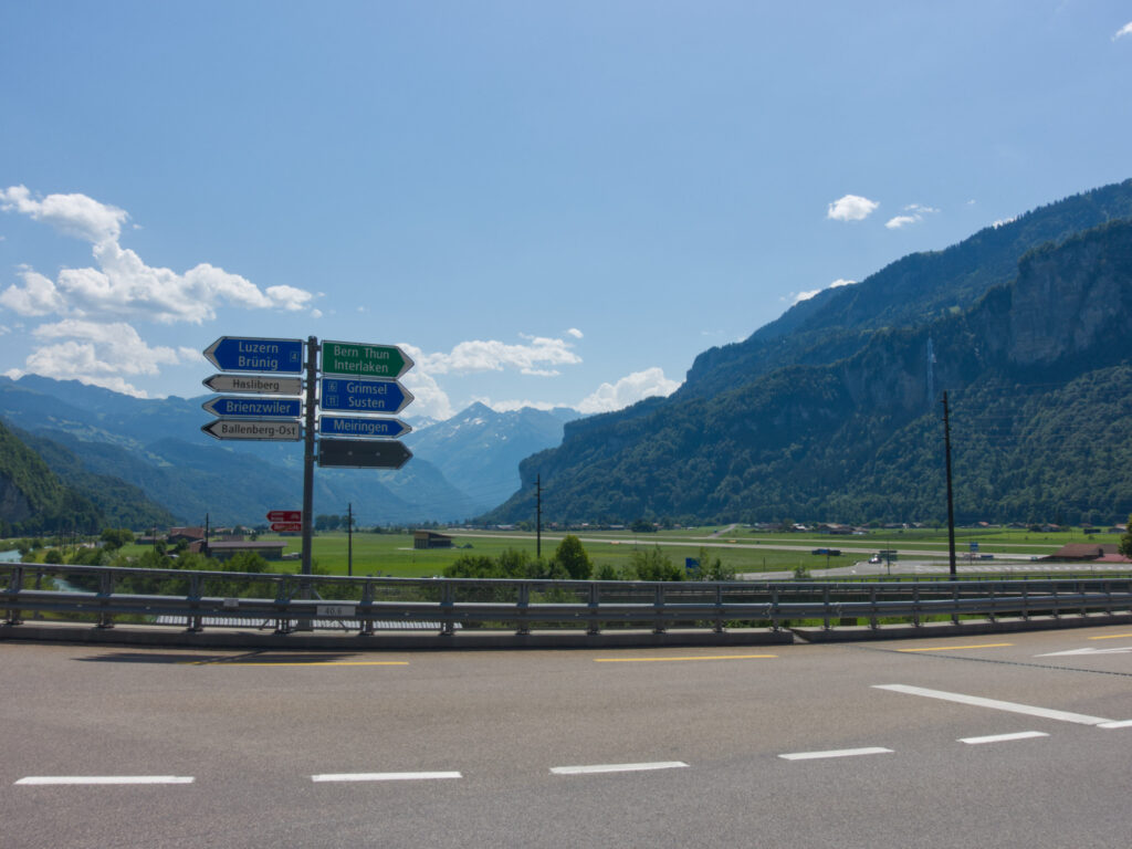 Road signs to Susten and Grimsel passes in the Swiss Alps near Meiringen.