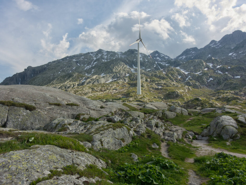 Wind turbine among the rocky peaks of Gotthard Pass.